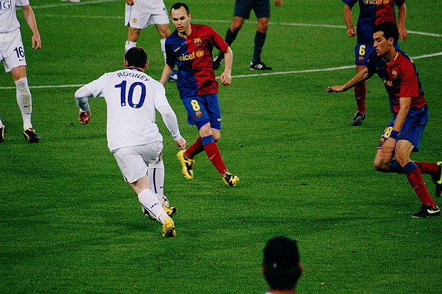 File:Rooney defended by Iniesta, Busquets, UEFA Champions League Final 2009.jpg